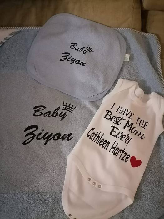 Grey baby towel and burp cloth printed Baby Ziyon, beside a bodysuit reading I have the best mom ever