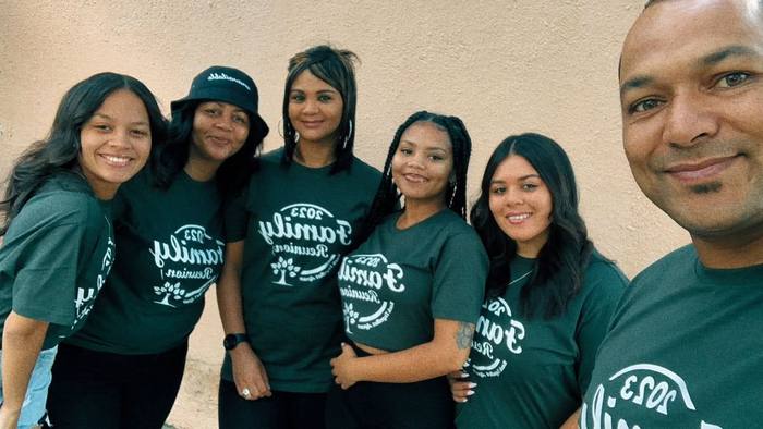 Six family members in matching dark green Family Reunion 2023 t-shirts with a tree design