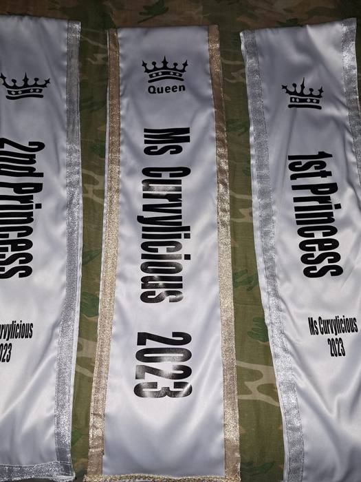Three white satin pageant sashes printed Queen, First Princess and Second Princess for Ms Curvylicious 2023