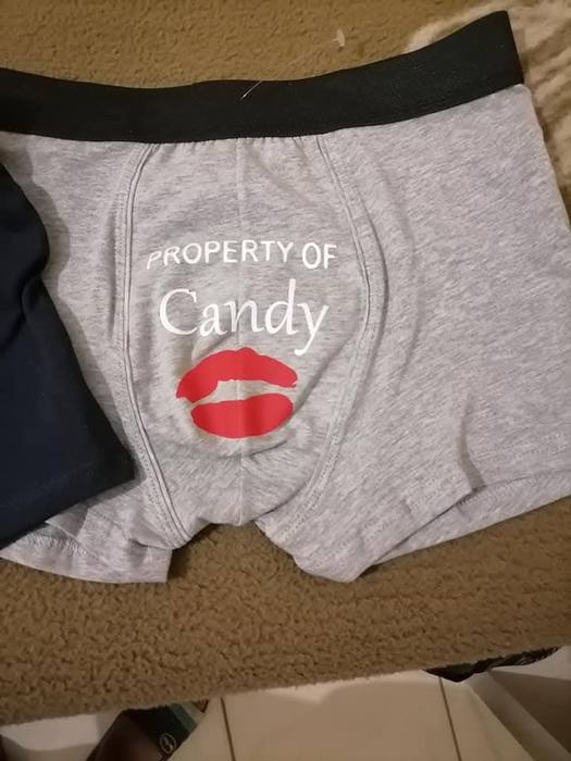 Grey boxer shorts printed Property of Candy below a red lip print