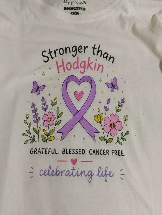 Cream t-shirt printed Stronger than Hodgkin around a lilac awareness ribbon, with the words grateful, blessed, cancer free